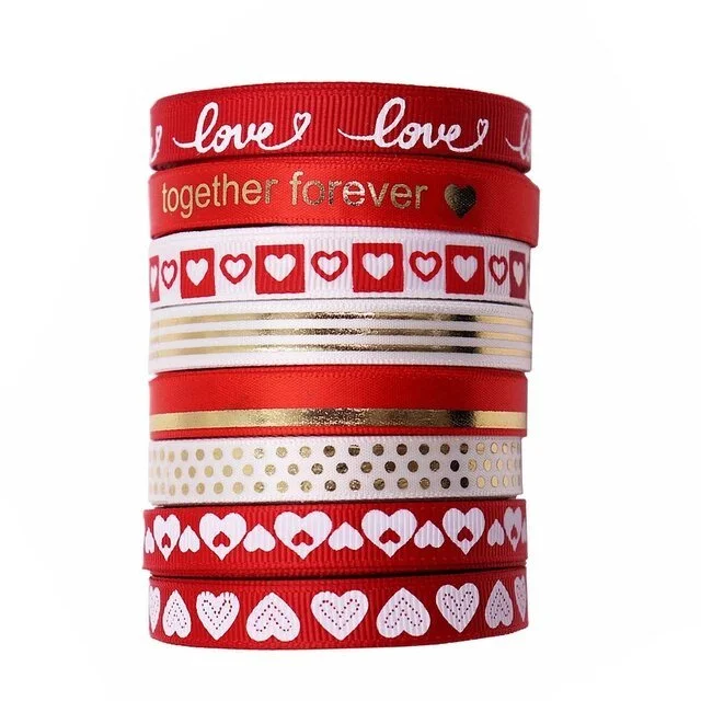 Stack of red ribbons with love-themed patterns and gold accents
